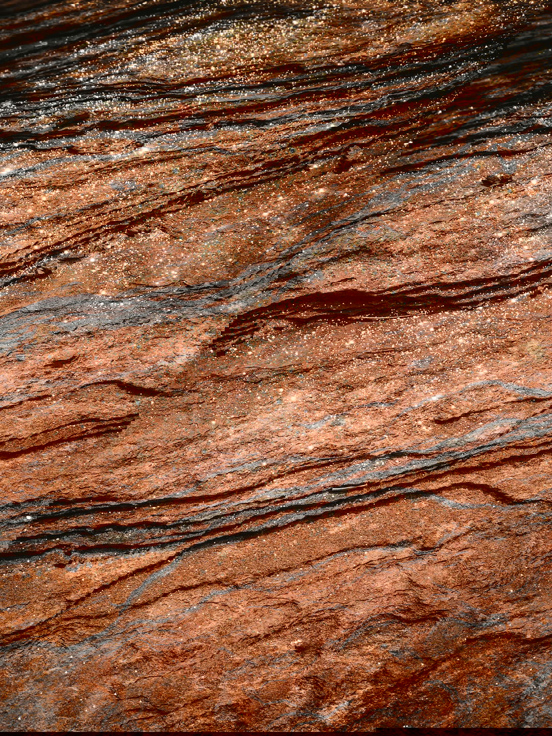 a close up of a rock surface with water